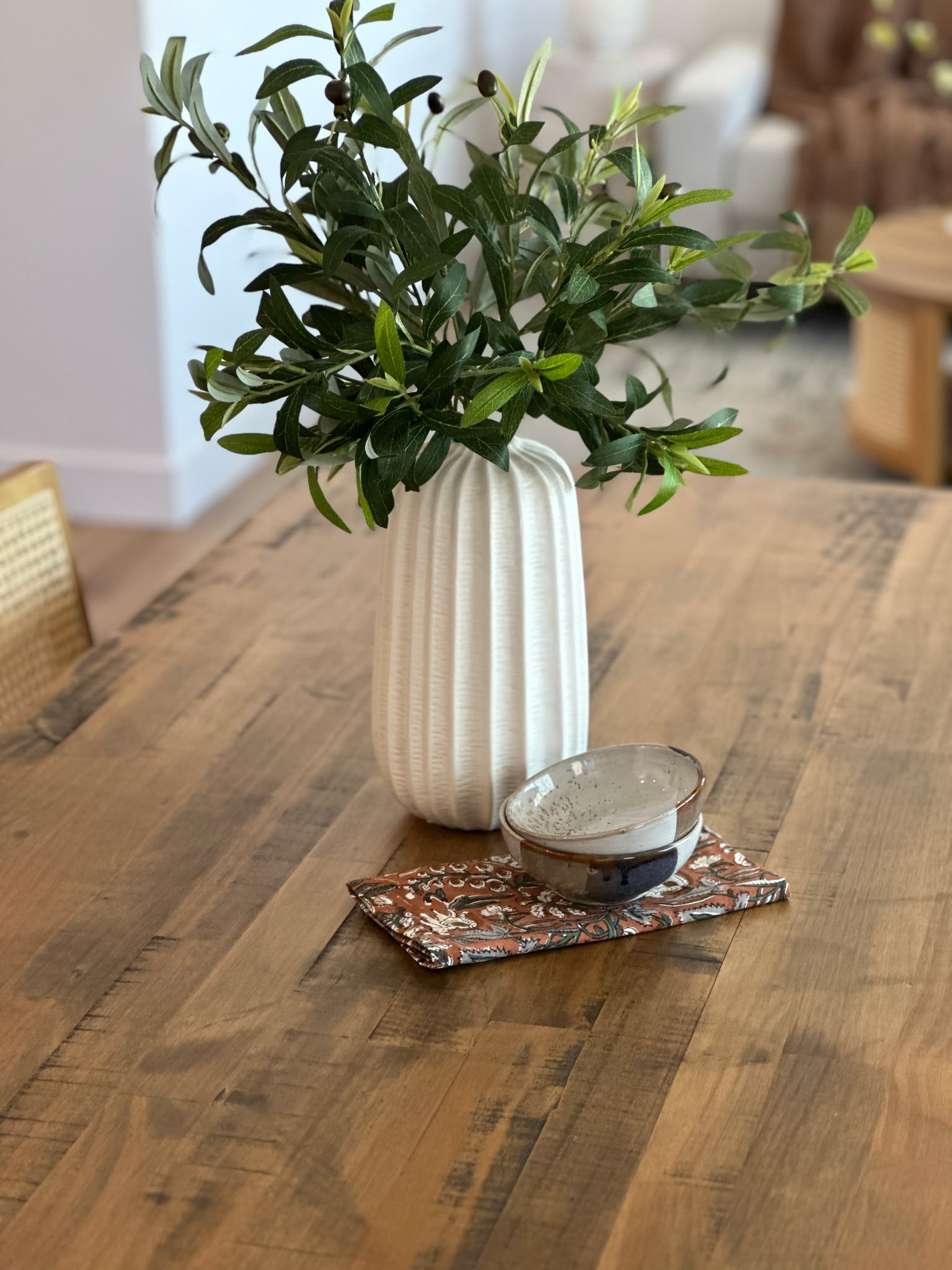 Close-up of a styled vase and bowl on a wood table