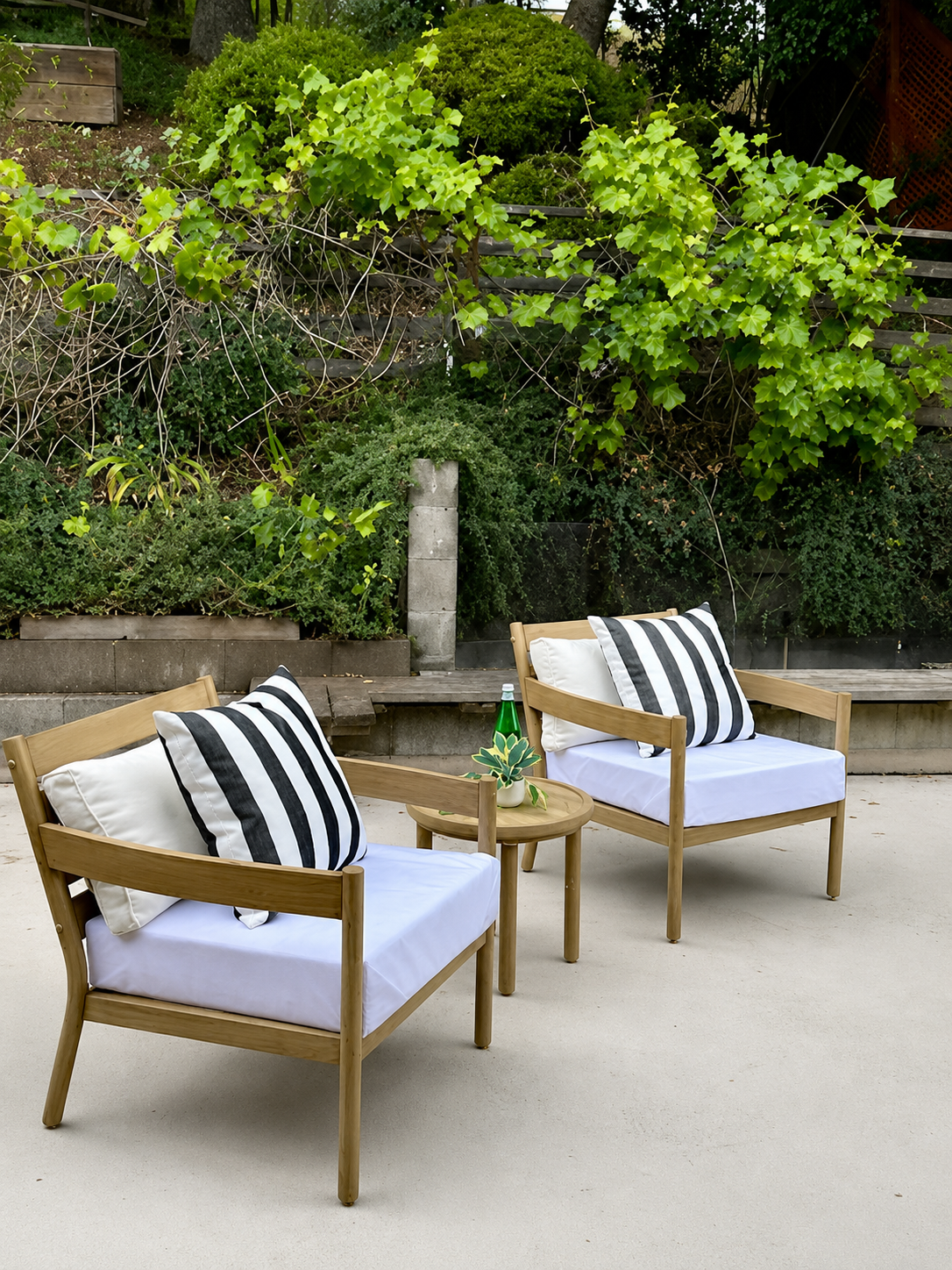 Outdoor patio chairs staged with striped pillows